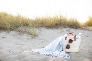 beach bag with blanket on sandy beach